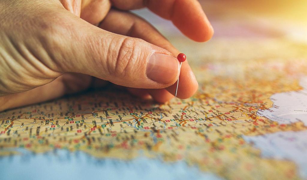 Travelers planning with digital devices outdoors