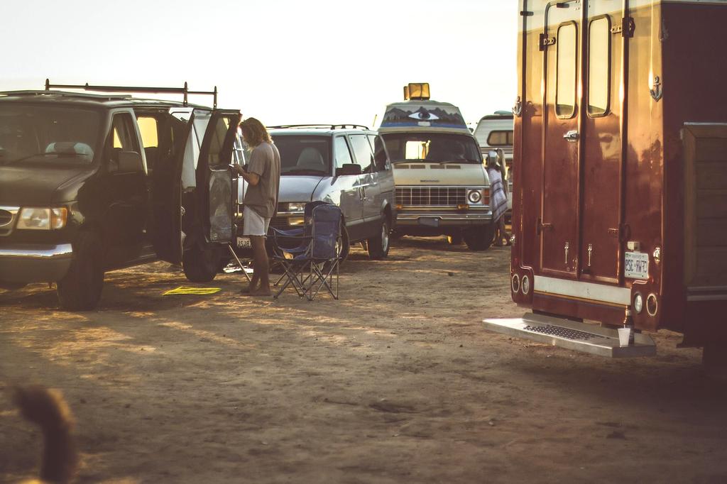 Scenic view of a mountain pass at sunset with a futuristic autonomous camper van