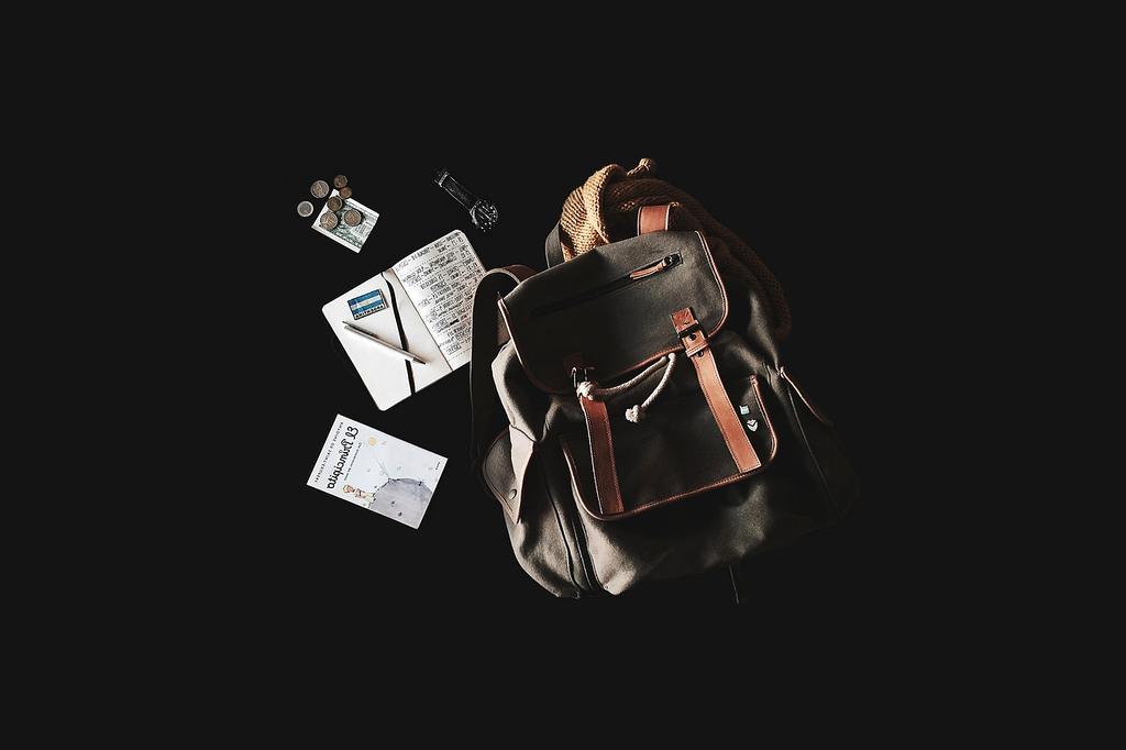 Books and digital travel resources on wooden desk