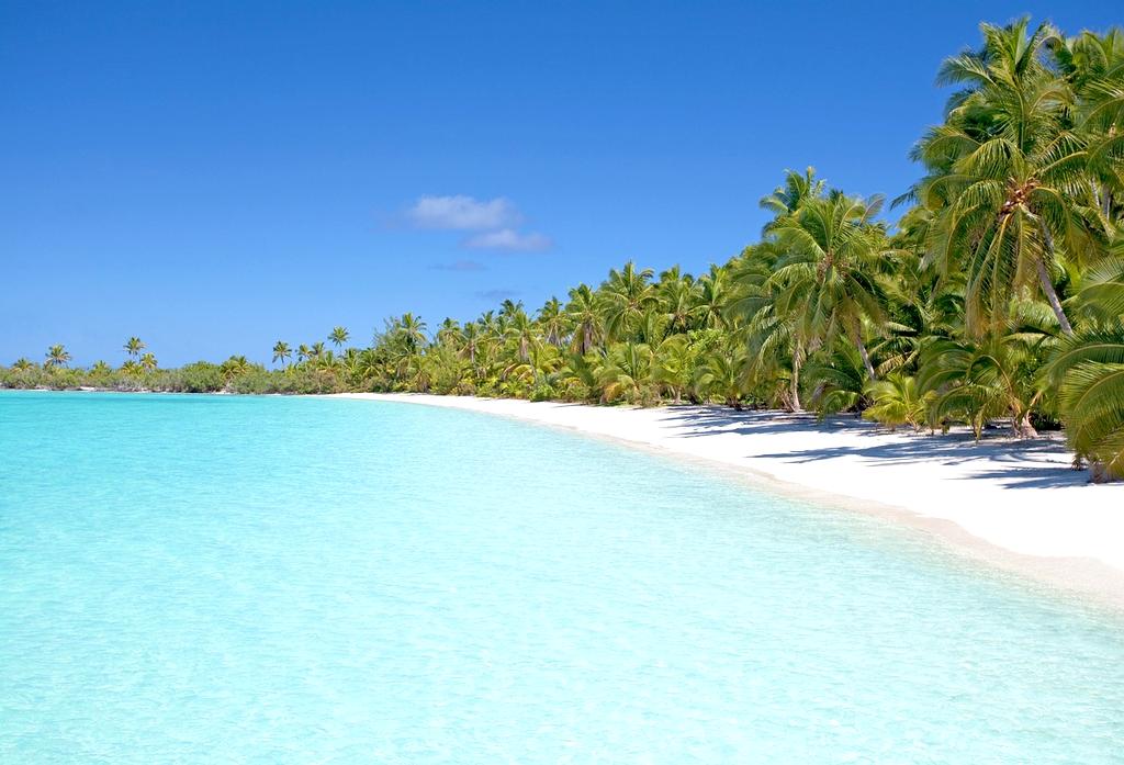 Panoramic aerial view of a tropical island with turquoise water and white beaches